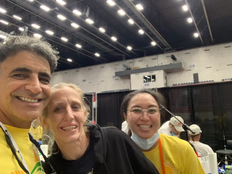 Dentists at a charity event where they help fix teeth for economically disadvantaged persons - With patient who looks happy.