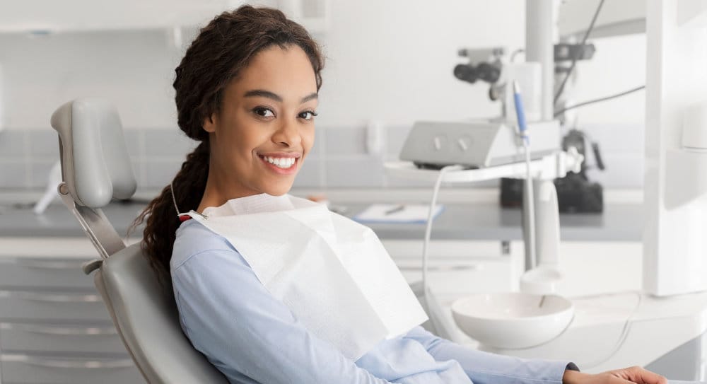 Happy woman sitting in a dentist's chair.